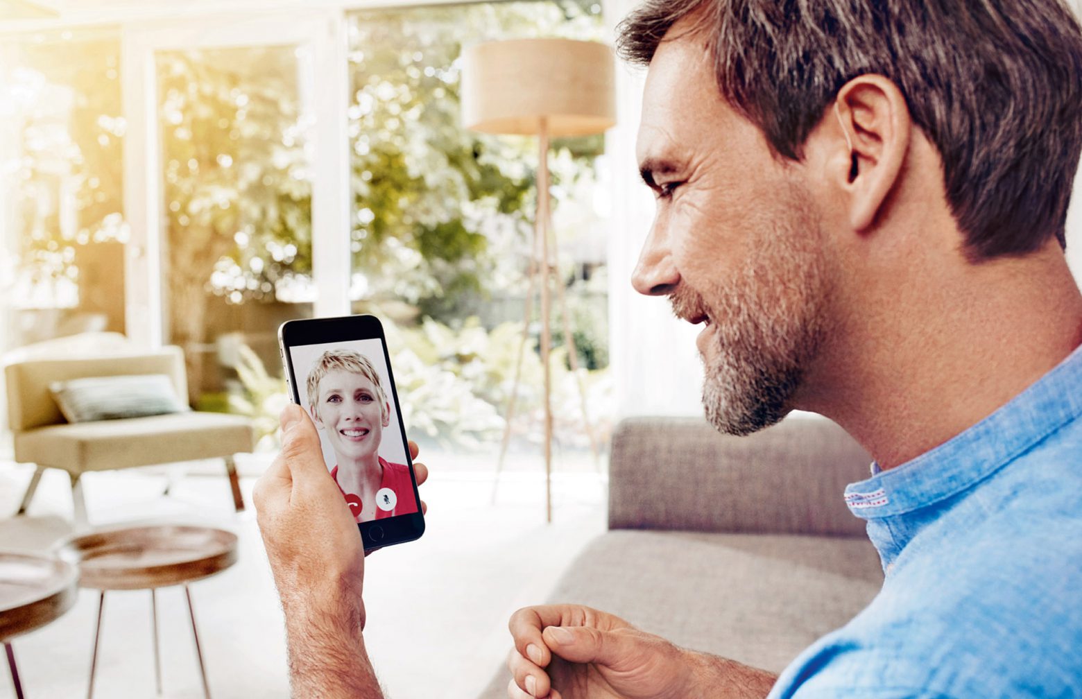 Man with hearing aids during a video call with his hearing care professinal