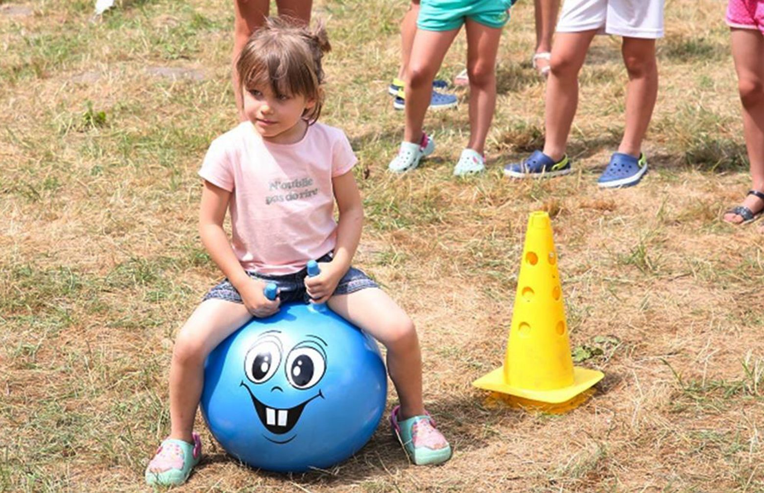 girl on a blue space hopper during the family day in Poland